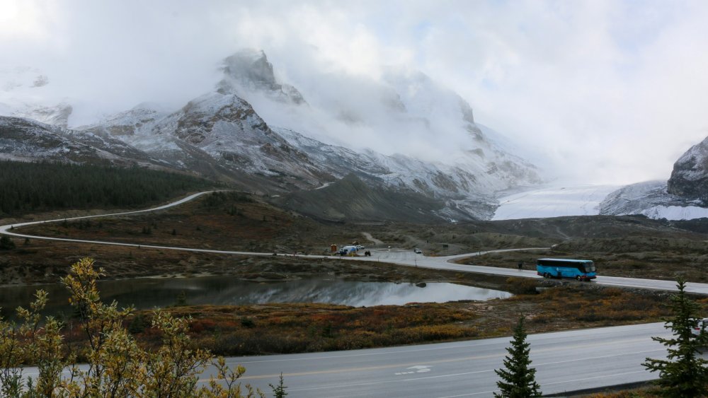 the size of the brewsters bus and other cars shows how vast the columbia icefields really is.   It is like driving into a different world.