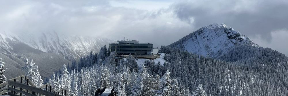 best attraction main banner image banff gondola with snowy peaked mountain looking at Sky Bistro and mountains in background 3x1 1000