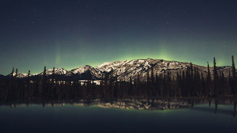 Norther Lights over Emerald Lake and reflection in the water 