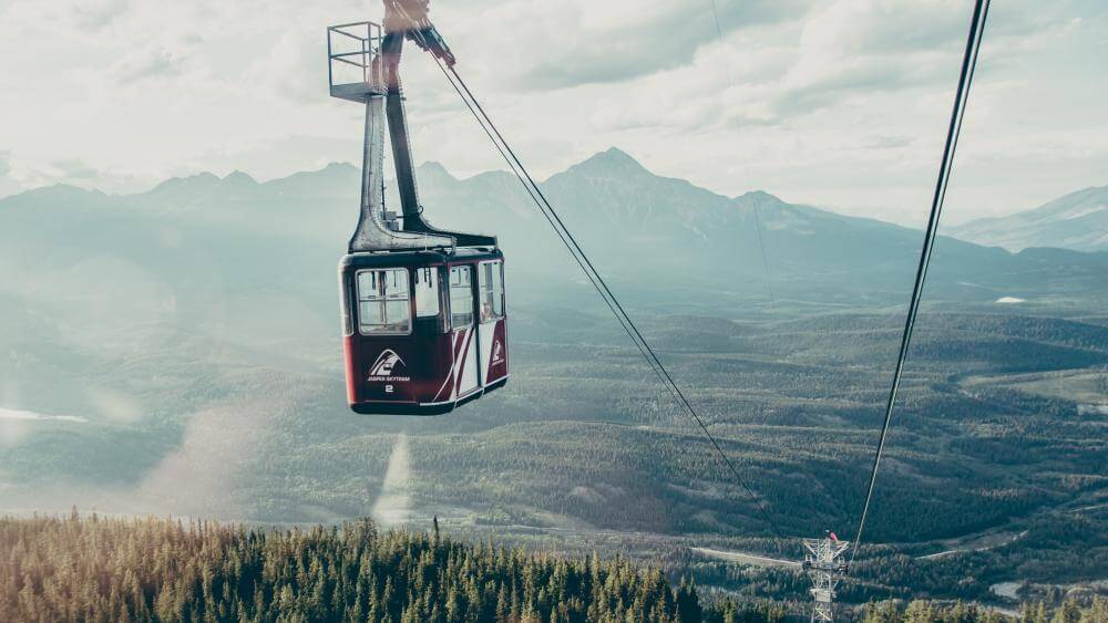 jasper tram going up over mountains with long range view