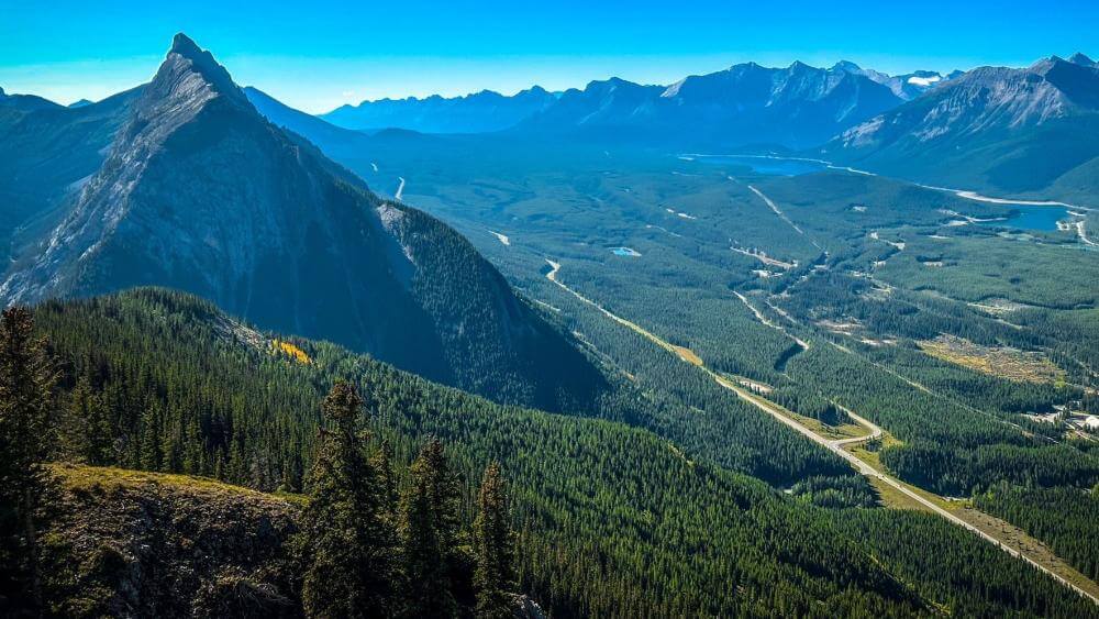 hiking in the clouds kananaskis main image banner looking down at kananaskis village