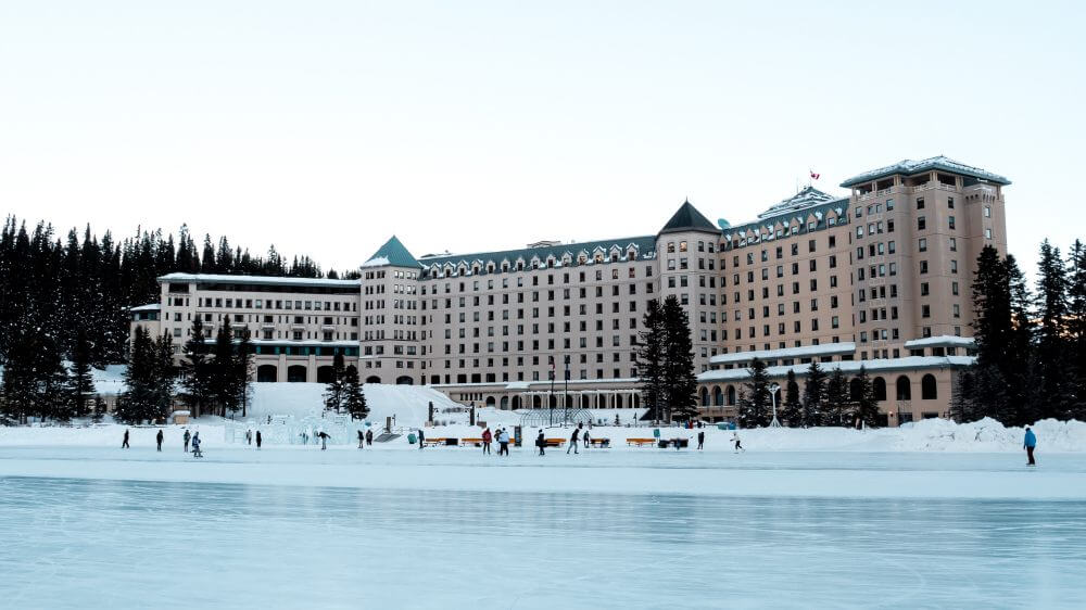 lake louise fairmont chateau in winter people skating on lake gallery pic