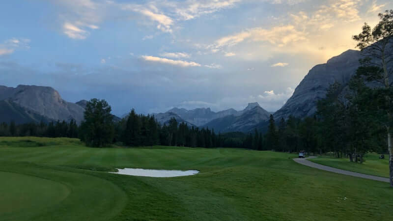 Kananakskis Mt Kidd 18th hole golf course looking south to sunset down the fairway from the green