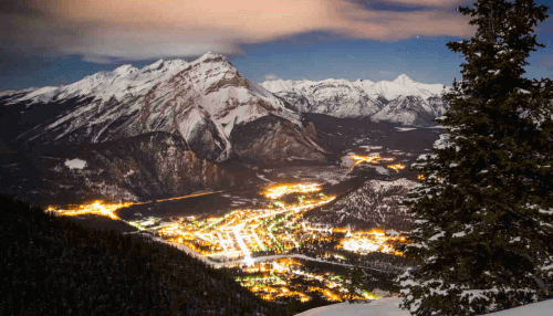 mountain top view of banff in early evening show the lights