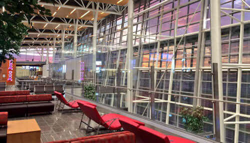 lounge at gate terminal looking through high windows at calgary airport